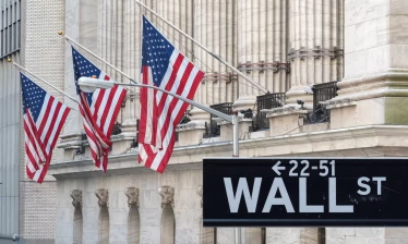 Wall Street building and sign with American flags