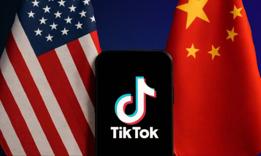Chinese and American flag with mobile device depicting TikTok logo