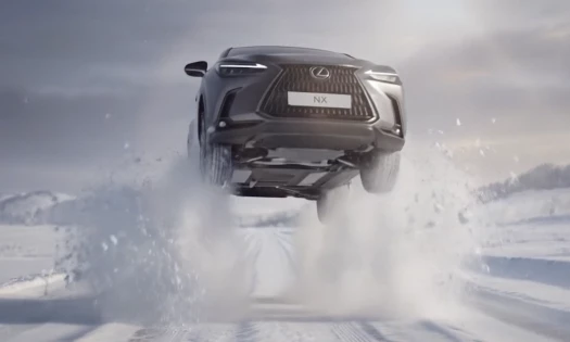 Lexus vehicle driving through the snow