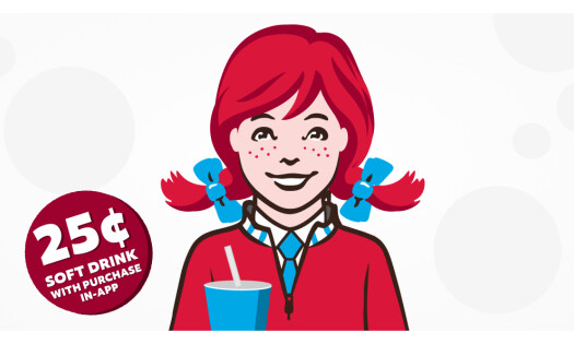 The Wendy's icon wearing a quarter zip