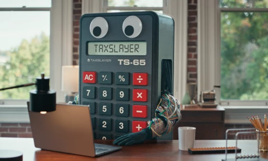 Calvin Calculator behind a desk