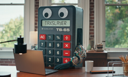 Calvin Calculator behind a desk