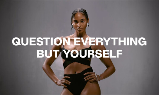 woman standing in a black swimsuit