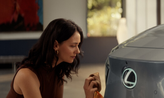 A woman shining her Lexus vehicle