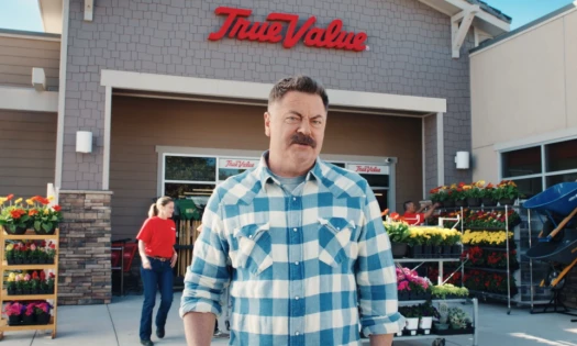 nick offerman talking in front of tru value building