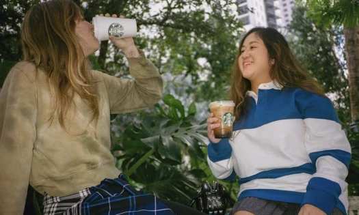 Two women enjoying a cup of Starbucks