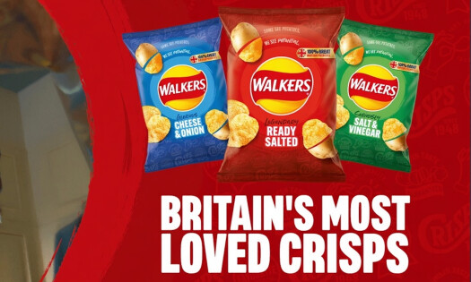 A photo of a bag of Walkers' new crisp flavor, Hot Honey, featuring its newly designed logo showing rays of light emanating from the center