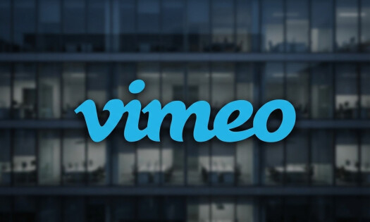 The Vimeo logo shown overtop of a background showing a corporate office building