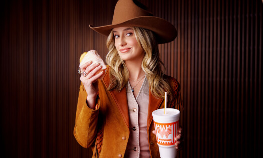 Lainey Wilson holding a Chicken Biscuit from Whataburger