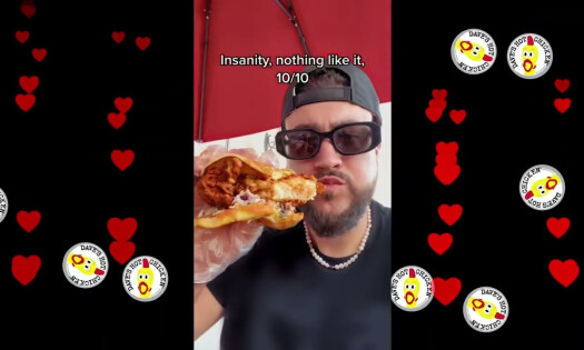 A fan eating Dave's Hot Chicken