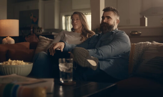 Jason and Kylie Kelce sitting on a sofa