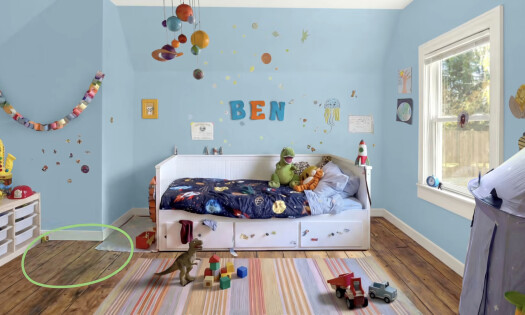 A young boy sitting on top of a kitchen counter while eating a tomato