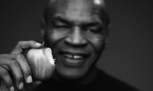 A close-up black and white shot of heavyweight champion Mike Tyson's face