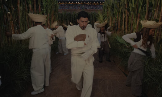 Bad Bunny pictured during his performance at the Super Bowl LX halftime show with Puerto Rican "farmers" in the background