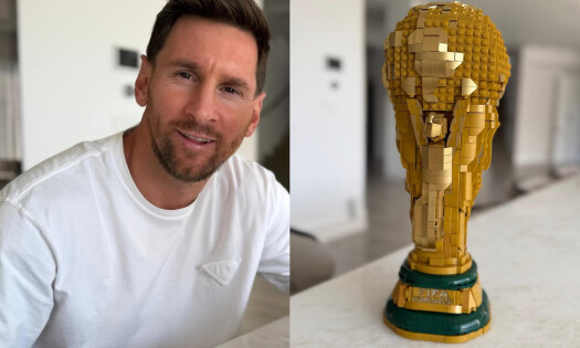 Lionel Messi showing off the LEGO he built of a FIFA World Cup trophy