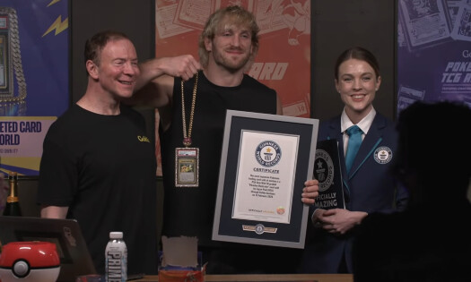 Logan Paul posing with a Guinness World Record and his Pokémon card