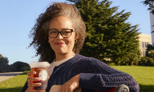 A photo of a woman holding a Starbucks cup
