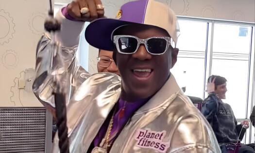 A photo of Flavor Flav standing inside a Planet Fitness gym, next to Instagram comments