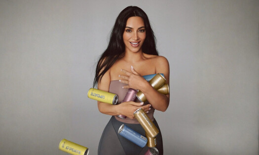 Kim Kardashian holding a bunch of UPDATE energy drink in her arms