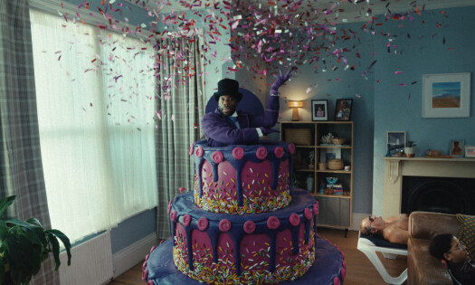A man coming outof a gigantic cake