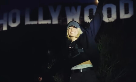 A close-up shot of Sydney Sweeney in front of a beige background