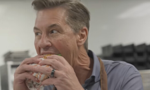 Burger King CEO taking a bite of the Whopper