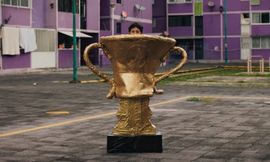 A screenshot from Axe's FIFA campaign spot "Airplane" showing a Mexican supporter wearing a home-made trophy costume