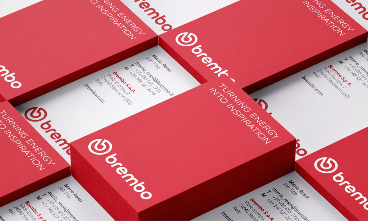 Business cards emphasize consistency and strong brand color