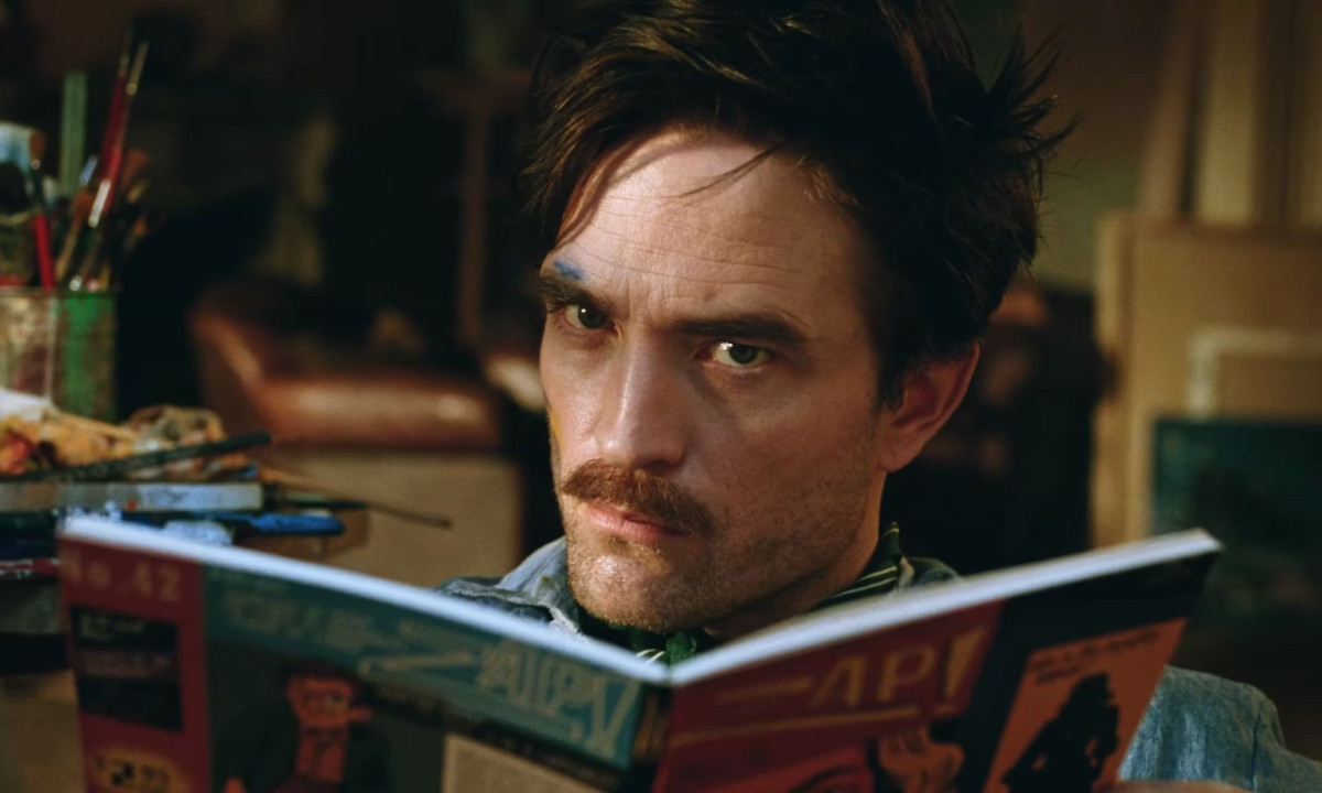 Close-up of man reading magazine in moody interior setting