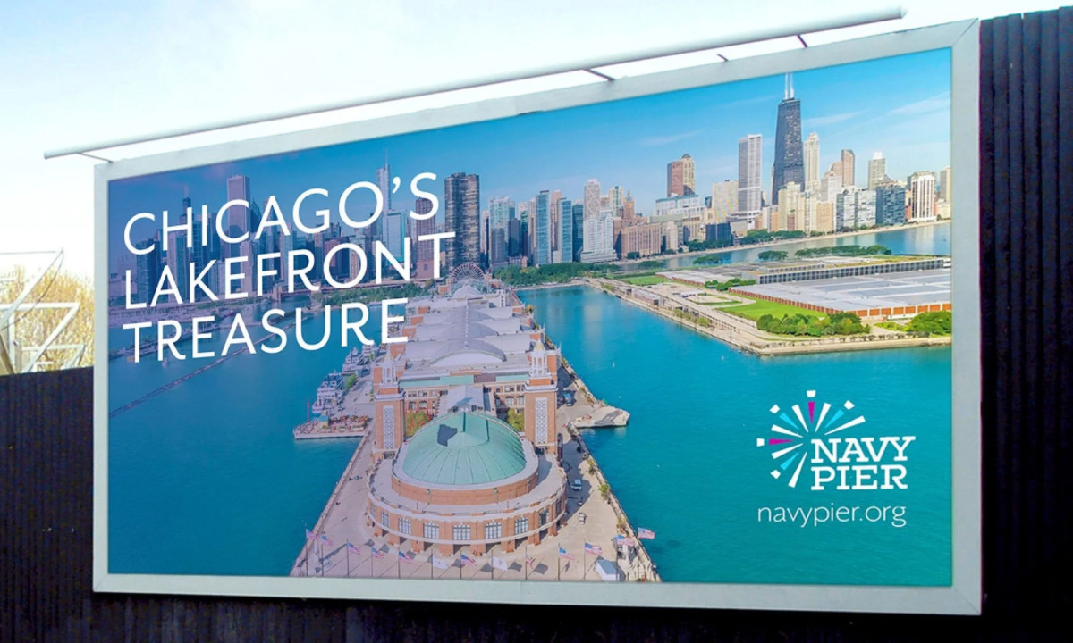 Billboard featuring Navy Pier branding and Chicago waterfront