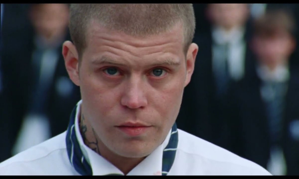 Close-up portrait of Yung Lean with a serious gaze