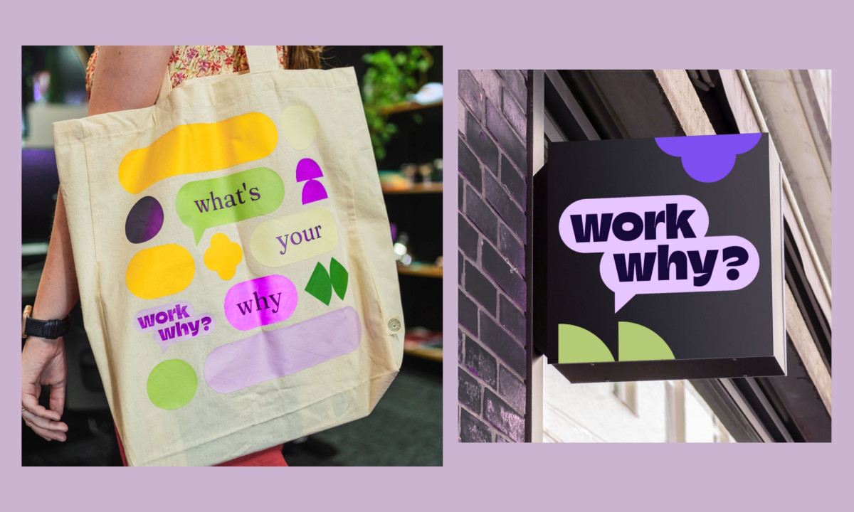 A canvas tote bag and square black storefront sign