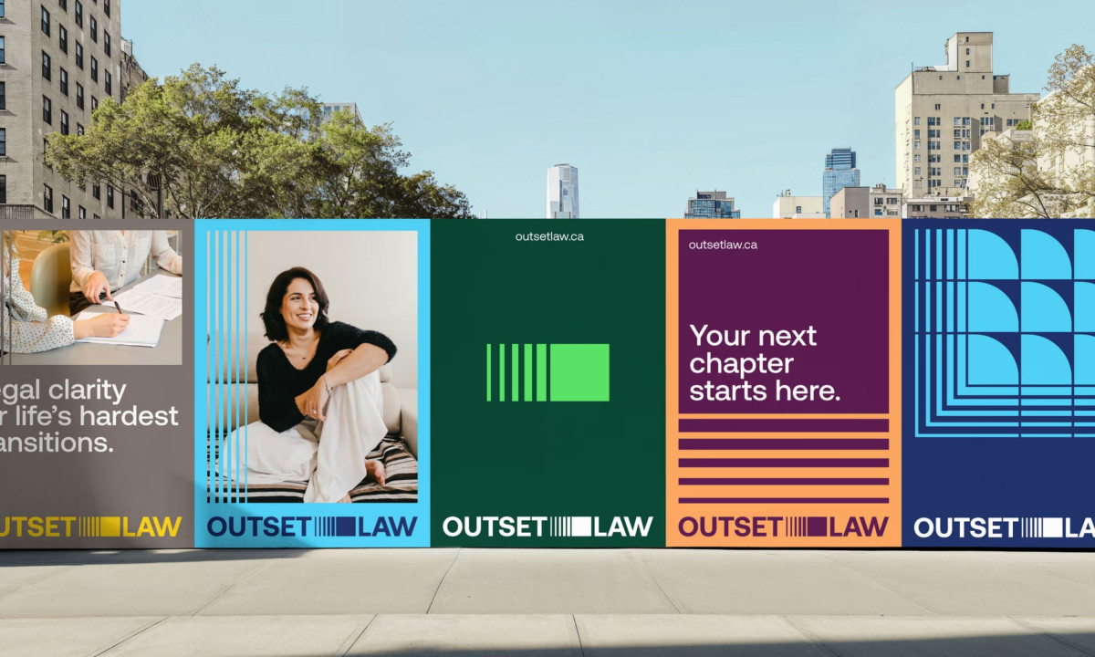 Five vibrant "Outset Law" posters mounted on a concrete wall outdoors