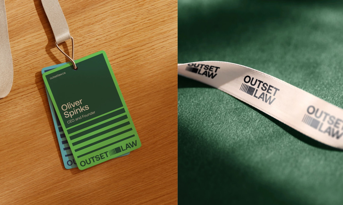 A close-up of a white lanyard and ID card holder with the "Outset Law" logo print