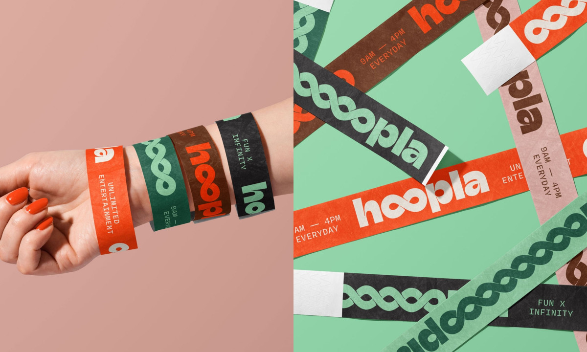 Multi-colored event wristbands worn on arm and scattered over green