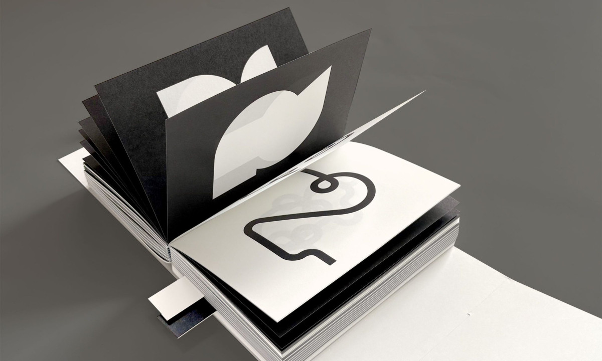 Thick publication reveals large contrasting typographic shapes.