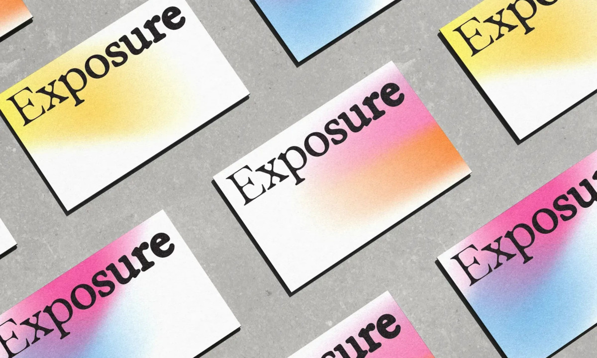 Colorful branding cards rest on a textured grey surface.