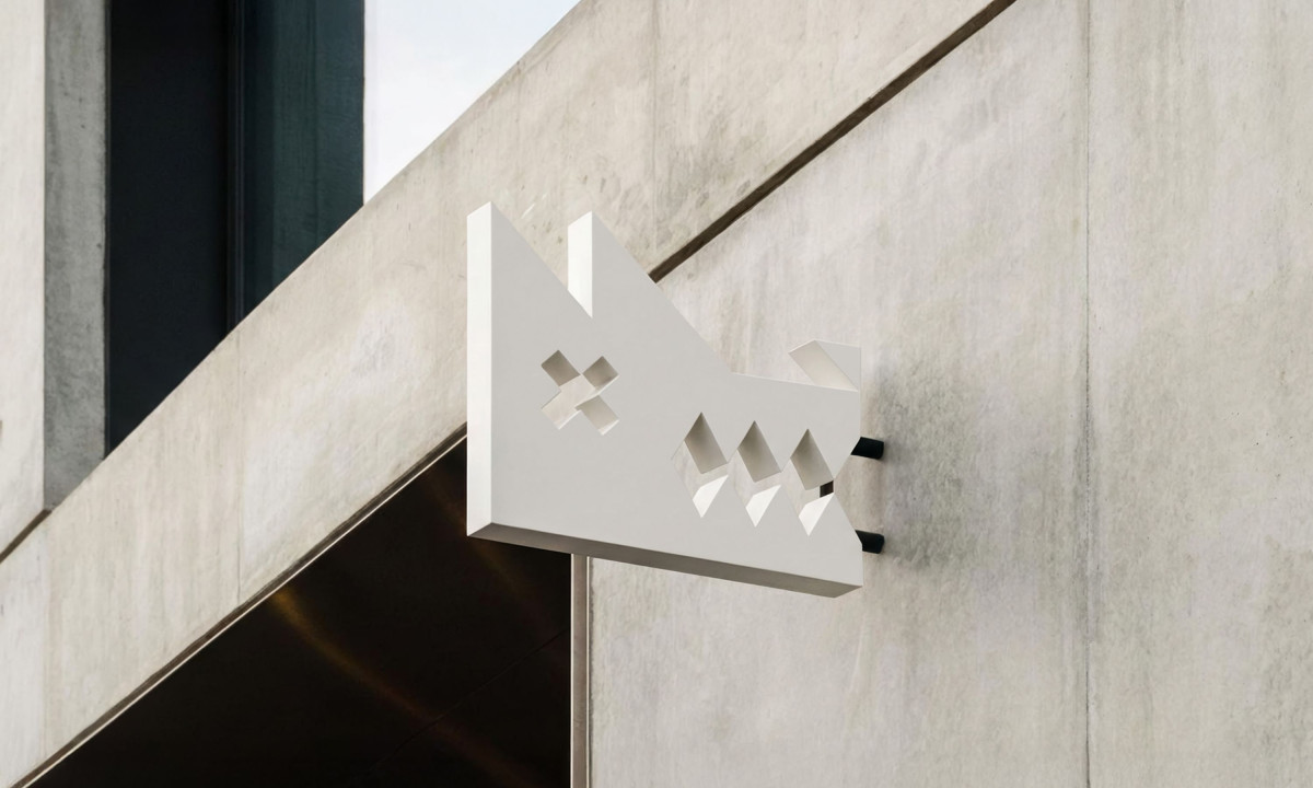 3D dog logo mounts on concrete.
