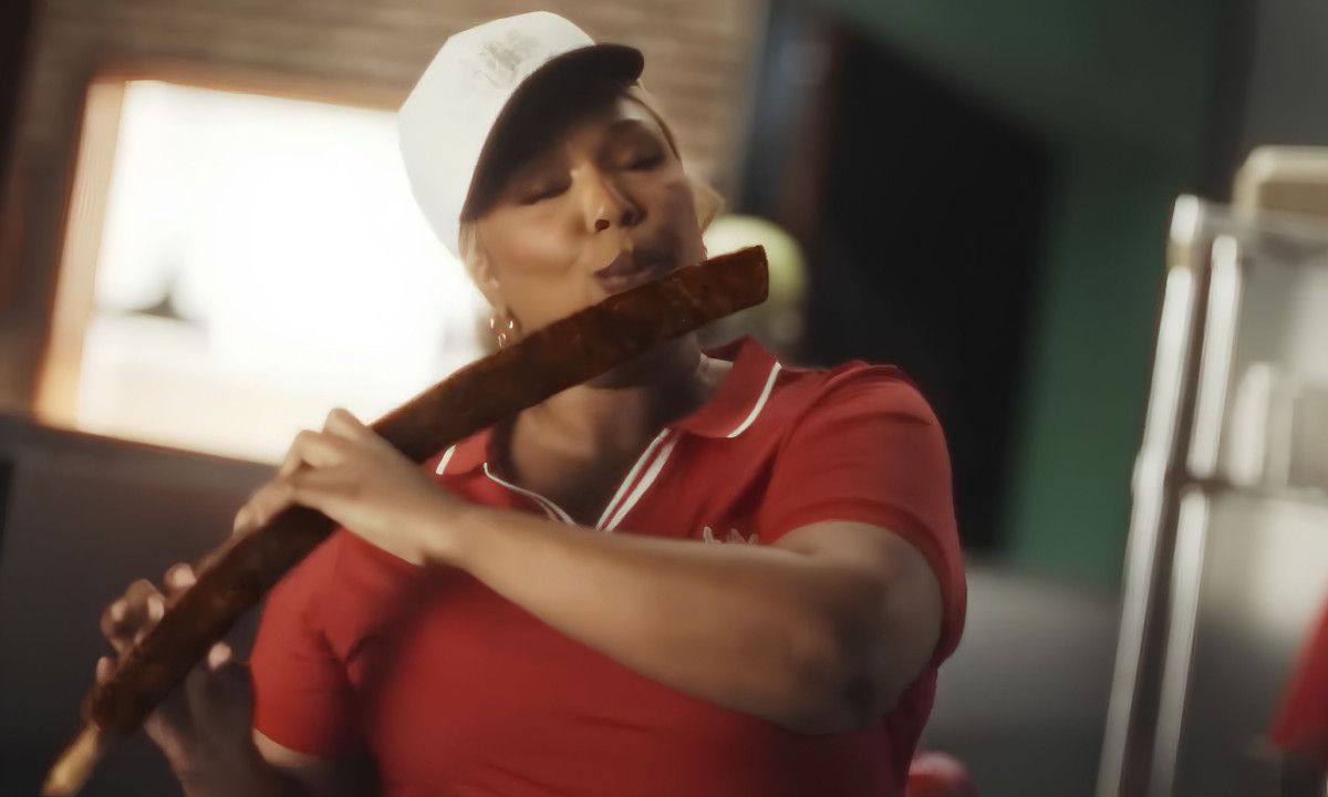 Uniformed woman plays a food stick like a flute.