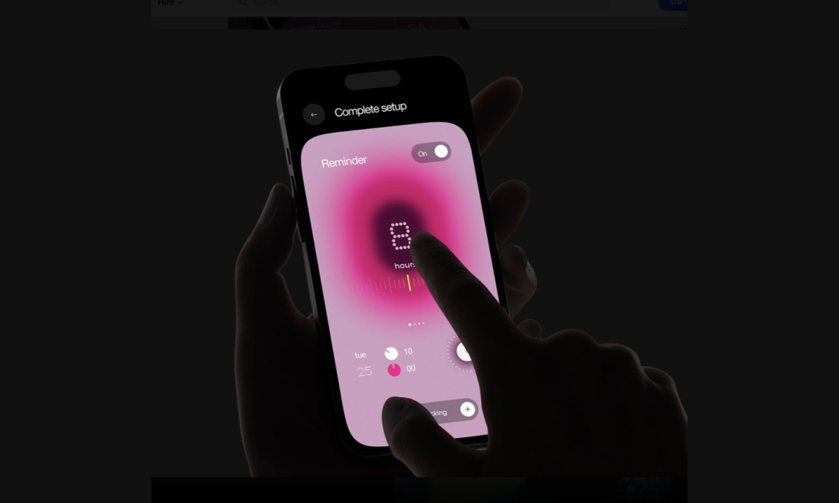 A hand holds a smartphone displaying a pink reminder setup screen with a digital dial.