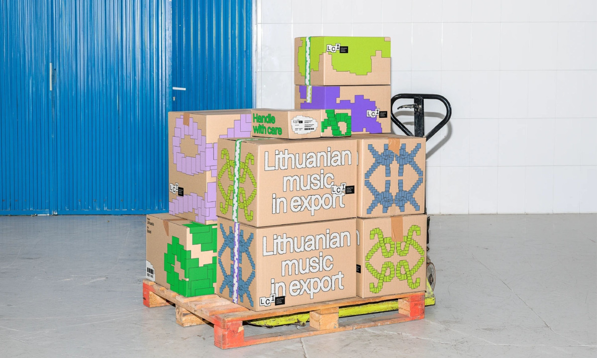 A wooden pallet holds stacked cardboard boxes featuring colorful pixelated graphics and "Lithuanian music in export" text.
