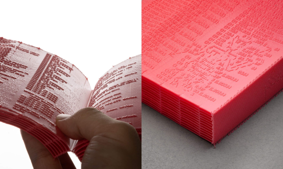 Hand opens a thick, bright pink 3D-printed book.