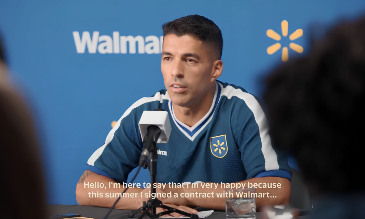 Luis Suárez addresses microphones at a Walmart press conference.