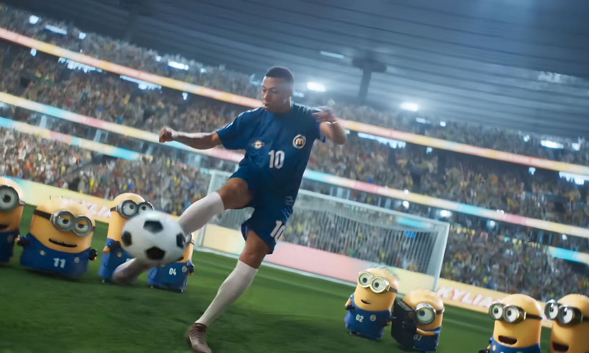 Kylian Mbappé kicks a soccer ball near small Minions.