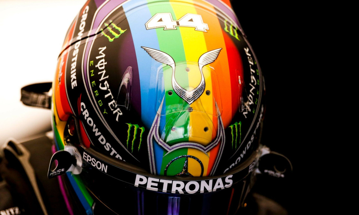 Rainbow striped racing helmet featuring Lewis Hamilton logo.