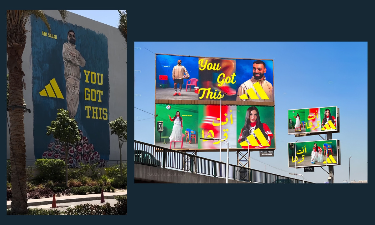 Large outdoor billboards displaying Mo Salah and Huda El-Mufti alongside Arabic text.