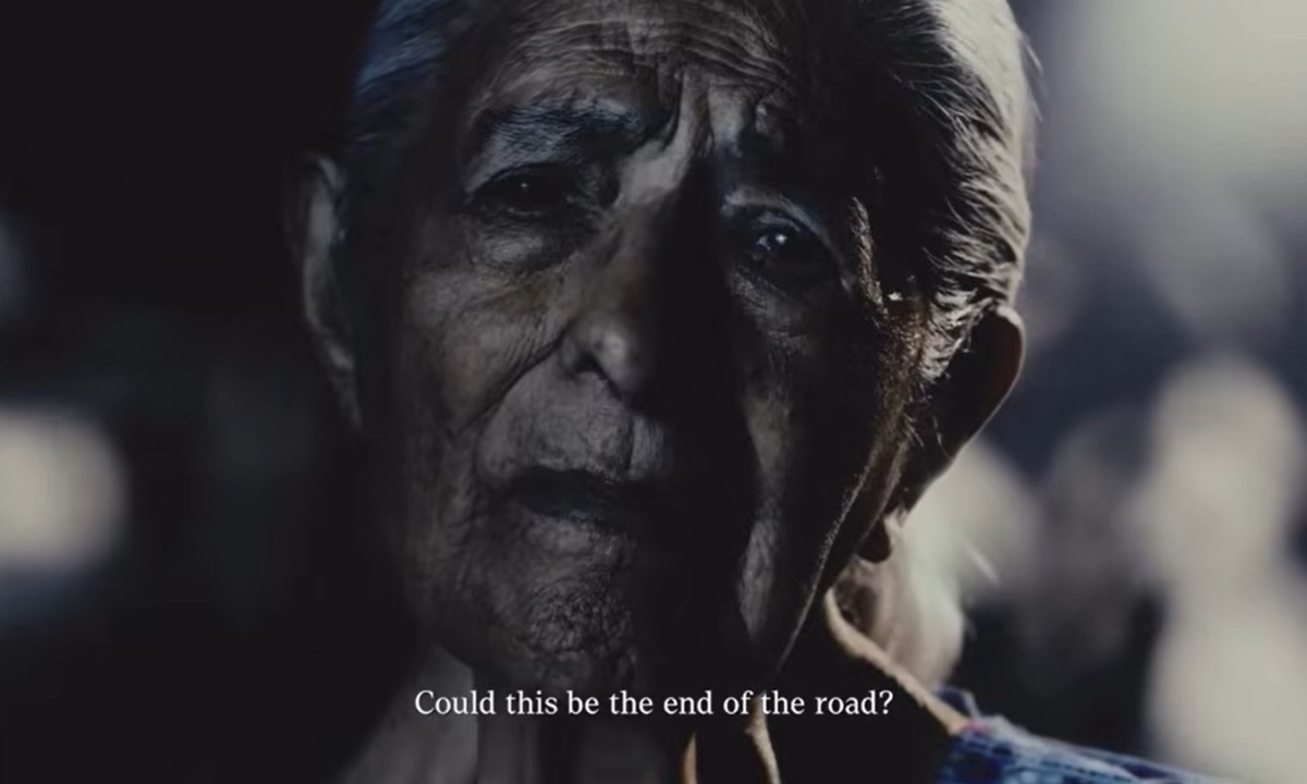 Older woman lit in the dark with the subtitle "Could this be the end of the road?"