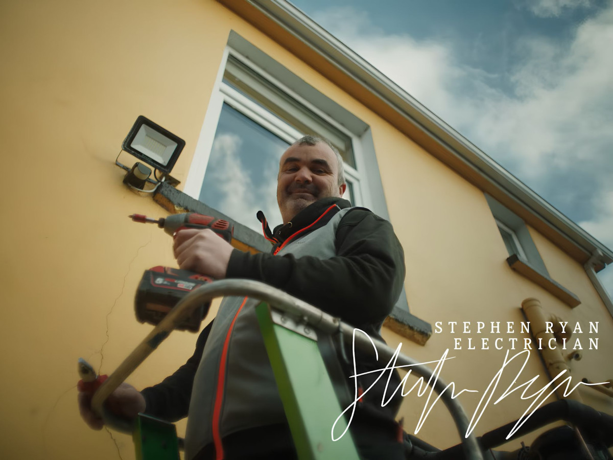 Man on a ladder holding a drill with text overlay.