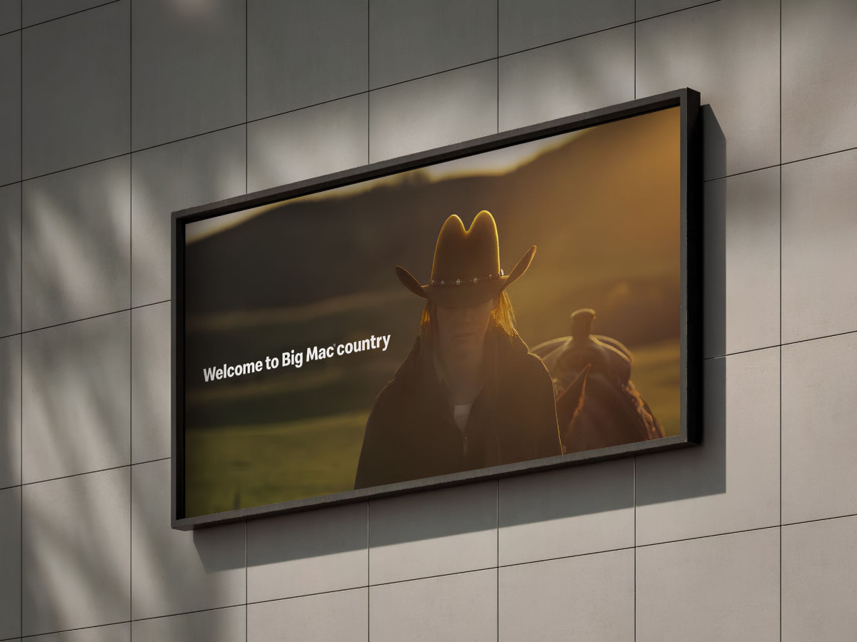 McDonald's billboard with a backlit cowboy hat resembling the Golden Arches.
