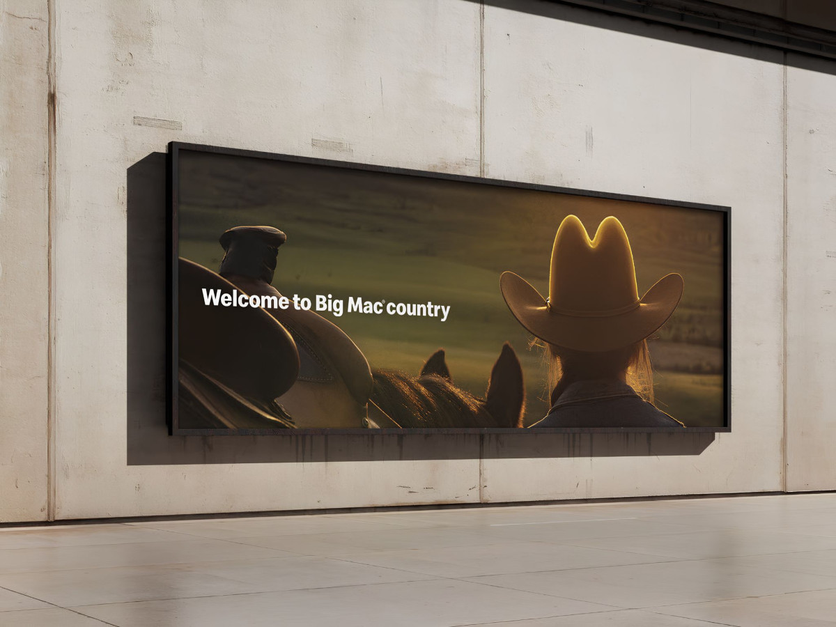 McDonald's billboard with a backlit cowboy hat resembling the Golden Arches.